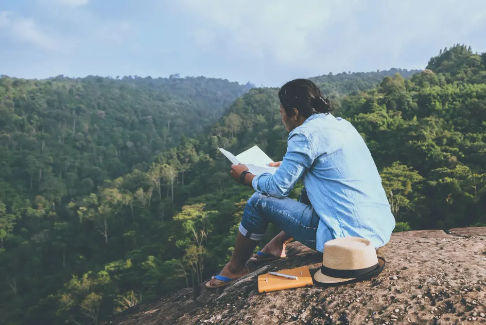 traveler reading a book outdoors